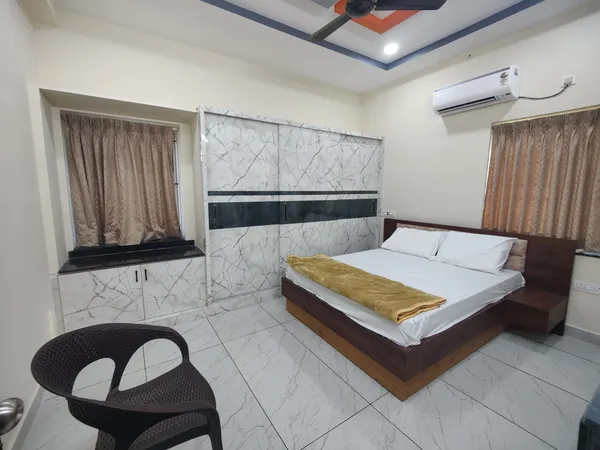 AC bedroom with wardrobe at Vaibhavam Vididhillu Machilipatnam