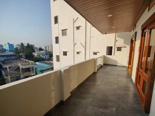 Green city view through window at Vaibhavam guest house